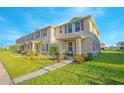 Beautifully landscaped townhome with a welcoming porch, offering great curb appeal in a friendly neighborhood at 1785 Red Canyon Dr, Kissimmee, FL 34744