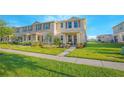 Charming townhome showcasing lush green lawn and well-maintained landscaping in a desirable community at 1785 Red Canyon Dr, Kissimmee, FL 34744