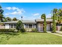 Inviting one-story home with a well-maintained lawn and classic architectural details at 1911 Canton St, Orlando, FL 32803