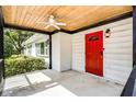 Welcoming front porch with a bright red door and a stylish ceiling fan at 1911 Canton St, Orlando, FL 32803