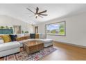 Bright and inviting living room featuring a large window, modern fan, and stylish décor at 2098 Heathwood St, Deltona, FL 32725
