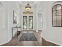 Welcoming foyer with decorative front doors, tiled flooring and decorative lighting at 2256 Kettle Dr, Orlando, FL 32835