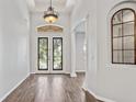 Inviting foyer with decorative front doors and archway features, and decorative lighting at 2256 Kettle Dr, Orlando, FL 32835