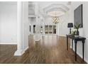 Bright, open living room features wood flooring, high ceilings, and elegant architectural columns at 2256 Kettle Dr, Orlando, FL 32835