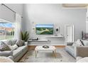 Bright living room with high ceilings, large windows, neutral tones, and comfortable seating at 255 Cordova Ave, Davenport, FL 33897