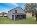 View of the backyard showing the screened-in patio at 2556 Volta Cir, Kissimmee, FL 34746