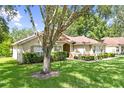 Well-kept single Gathering home with manicured front lawn, mature shade trees, and sidewalk path at 2613 Breezy Meadow Rd, Apopka, FL 32712
