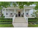 Inviting front porch with white railing, seating, and a welcoming entrance with a wreath at 2781 Stanfield Ave, Orlando, FL 32814