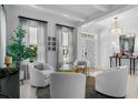 Bright living room with white walls, marble floors, stylish chairs, and elegant decor at 2781 Stanfield Ave, Orlando, FL 32814