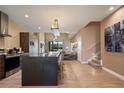 Open-concept kitchen with a large island, stainless steel appliances, and modern finishes at 3056 Rockefeller Way, Kissimmee, FL 34747