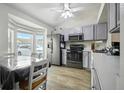 Functional kitchen with modern appliances, white cabinetry, and a cozy dining area at 3280 Villa Way Cir, St Cloud, FL 34769