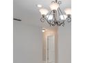An elegant chandelier and hallway entrance to the bathroom at 3519 Gatlin Place Cir, Orlando, FL 32812