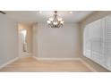 Inviting dining room featuring wood flooring and a stylish chandelier at 3519 Gatlin Place Cir, Orlando, FL 32812