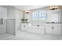 Elegant bathroom with a soaking tub, dual vanities, a glass-enclosed shower, and bright natural light at 426 Veneto Cir, Clermont, FL 34715