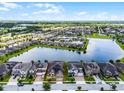 Aerial view of community homes next to the water with solar panels at 5029 Hartwell Ct, St Cloud, FL 34771