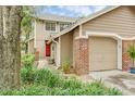 A well-maintained home with a prominent red front door and attached garage at 641 Maple Oak Cir # 101, Altamonte Springs, FL 32701
