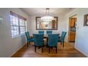 Elegant dining room with a chandelier, large mirror, and seating for six at 901 Candle Berry Rd, Orlando, FL 32825