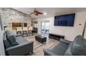 Contemporary living room featuring stylish seating, a stone accent wall, and an open layout at 901 Candle Berry Rd, Orlando, FL 32825