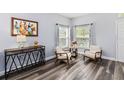 Sitting area features new flooring, light gray walls, and lots of natural light from two windows at 9067 Stonebury Way, Orlando, FL 32832