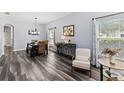 Open-concept living area features a wood dining table with seating and lots of natural light at 9067 Stonebury Way, Orlando, FL 32832