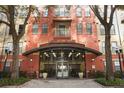 Inviting building entrance featuring grand doors, decorative lighting, and professional landscaping at 911 N Orange Ave # 143, Orlando, FL 32801