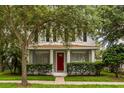Inviting front porch view with a red front door and a well-kept lawn at 10117 Sweetleaf St, Orlando, FL 32827