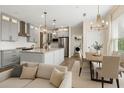 Open-concept living area featuring a modern kitchen, dining space, and comfortable seating at 10117 Sweetleaf St, Orlando, FL 32827