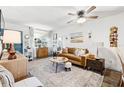 Cozy living room showcasing modern decor, a comfortable sofa, and ample natural light for a welcoming atmosphere at 1100 E Caroline St # 204, Tavares, FL 32778