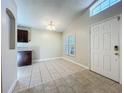 Bright dining room area with tile flooring, a decorative light fixture, and plantation shutters at 1115 Naples Dr, Orlando, FL 32804