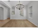 Elegant dining room features hardwood flooring, a modern chandelier, and lots of natural light at 12884 Penshurst Ln, Windermere, FL 34786