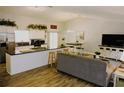 Bright, open-concept living space with a modern kitchen, wood floors, and dining area at 1361 Sterling Oaks Dr, Casselberry, FL 32707