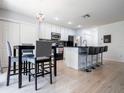 Eat-in kitchen featuring stainless steel appliances, dark countertops, and modern lighting at 2006 Stone Abbey Blvd, Orlando, FL 32828