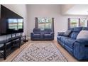 Comfortable living area featuring modern furniture, hardwood floors, and a large window for natural light at 2006 Stone Abbey Blvd, Orlando, FL 32828