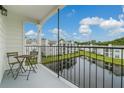Relaxing balcony with table and chairs overlooking a scenic water view at 2550 Alafaya Trl # 9303, Orlando, FL 32826