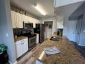 Well-equipped kitchen features stainless appliances, wood cabinets and granite counters at 2550 Alafaya Trl # 9303, Orlando, FL 32826