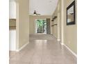 Hallway view leading to the carpeted living room through sliding glass doors at 33243 Kaylee Way, Leesburg, FL 34788