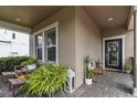 Cozy front porch with comfortable seating, decorative plants, and stylish decor at 3404 Shallow Cove Ln, Clermont, FL 34711