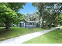 Charming single-story home with a well-maintained lawn, mature trees, and inviting curb appeal at 3501 Amigos Ave, Orlando, FL 32808