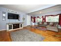 Comfortable living room with hardwood floors, stylish furniture, and plenty of natural light at 3501 Amigos Ave, Orlando, FL 32808