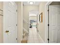 Bright hallway with access to the pool area, a staircase, and tiled floors at 4558 Baleno Ln, Kissimmee, FL 34746