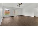 Bright and airy living room features wood-look floors, backyard access, and a ceiling fan at 4836 Pierce Arrow Dr, Apopka, FL 32712