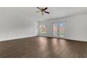 Spacious living room features modern ceiling fan, backyard access, and sleek wood-look floors at 4836 Pierce Arrow Dr, Apopka, FL 32712