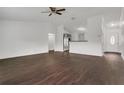 Open-concept living room boasts wood-look floors and an abundance of natural light at 4836 Pierce Arrow Dr, Apopka, FL 32712
