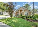 Inviting exterior view with lush green lawn and mature landscaping highlighting this beautiful home's curb appeal at 538 Majestic Oak Dr, Apopka, FL 32712