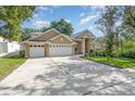 Well-maintained home boasting a three-car garage and landscaped front yard, perfect for curb appeal at 538 Majestic Oak Dr, Apopka, FL 32712