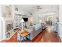 Cozy living room features stylish furnishings, hardwood floors, and a charming fireplace at 538 Majestic Oak Dr, Apopka, FL 32712