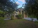 Charming single-story home with mature trees and well-maintained landscaping at 679 Midori St, Orlando, FL 32811