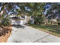View of the driveway leading to an attached two-car garage on a sunny day at 7219 Hunterdon Dr, Orlando, FL 32835