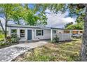 Charming single-story home with a well-maintained front yard and distinctive concrete privacy wall at 7601 Aviano Ave, Orlando, FL 32819