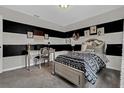 Stylish bedroom featuring modern black and white stripes, sleek silver furniture, and coordinated decor at 11158 Hollow Bay Dr, Winter Garden, FL 34787